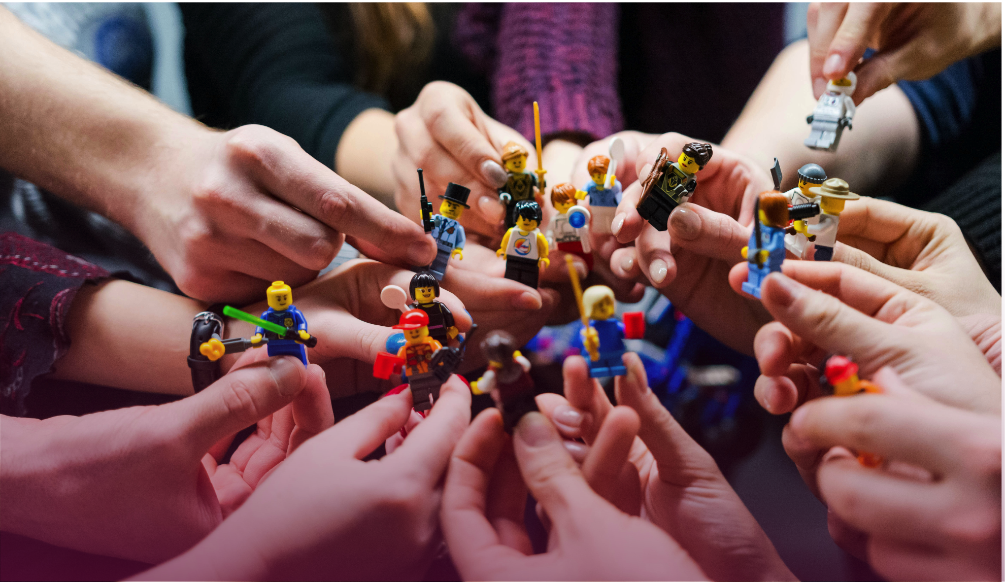 People holding small figures together